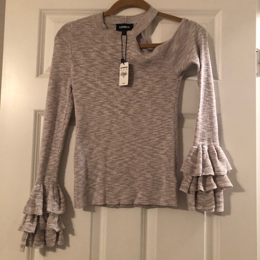Cream shirt with exposed shoulder and ruffles